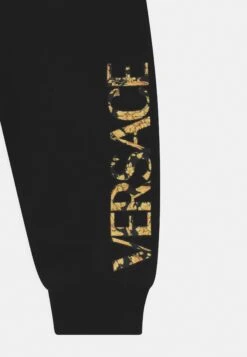Versace Logo Unisex - Trousers - Nero/Oro -Kids Clothing Shop 16d8e998f4ff41cdb45fa6311ba38e72